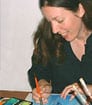 Photo of author MLP illustrating a picture book with a red marker